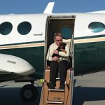 Puppy with man on plane