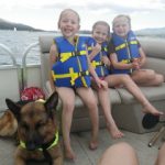 German Shepherd on boat with kids