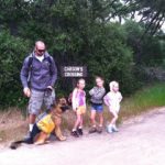 German Shepherd on trail with kids