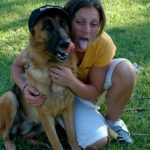German Shepherd and woman with tongues out