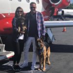 German Shepherd with family and plane