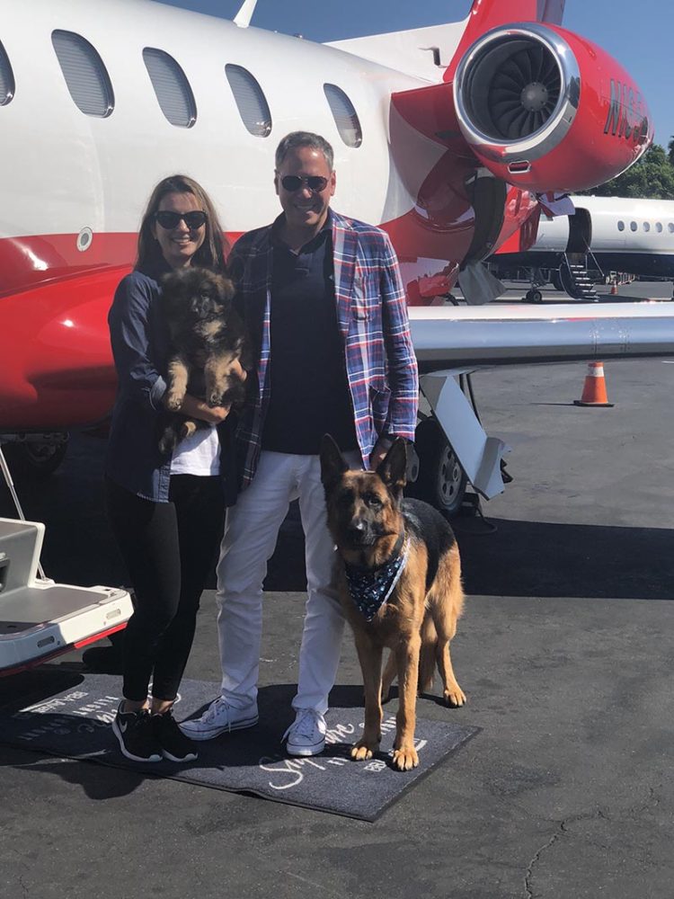 German Shepherd with family and plane